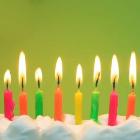 Candles lit on a birthday cake.