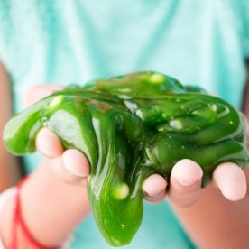 A young girl plays with play foam slime.