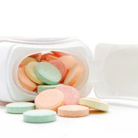 A bottle of tums laying on its side.