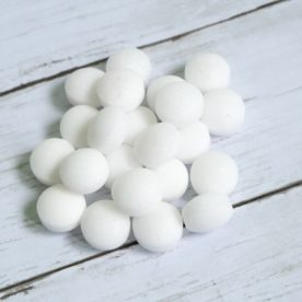 A pile of white mothballs on a wooden deck.