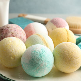 An assortment of colorful round bath bombs on a platter.