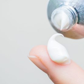 A small amount of Nystatin in lotion on someone's finger tip.