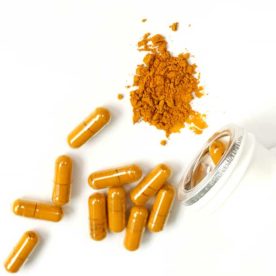 Turmeric capsules on a white background.