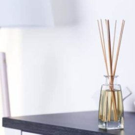 A bottle of liquid air freshener sits on a table.