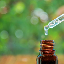 a vial of tea tree oil with a dropper
