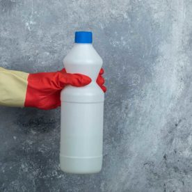 person holding bottle of bleach