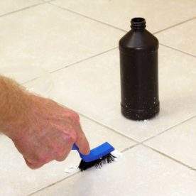 person scrubbing floor with hydrogen peroxide