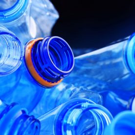 plastic water bottles sitting on one another.
