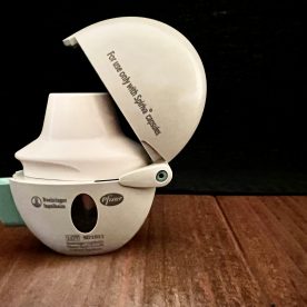 A Spiriva® Handihaler® sitting on a wooden table.