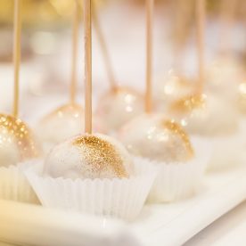 white cake pops with gold luster dust