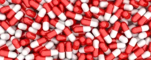 Pile of red and white capsule pills