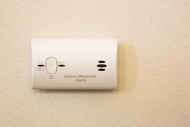 A Carbon Monoxide Alarm Attached To A Wall In Someone's Home.