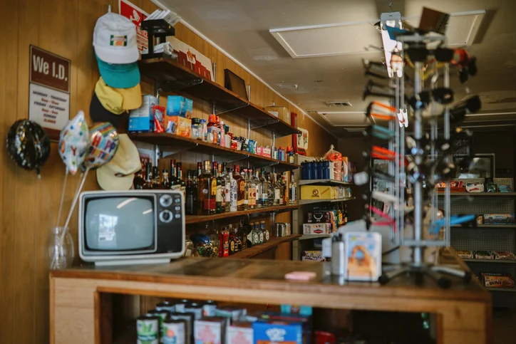 The inside of an established convenience store with various products stacked on its shelves.