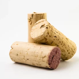 Three wine corks on top of each other on a white background.