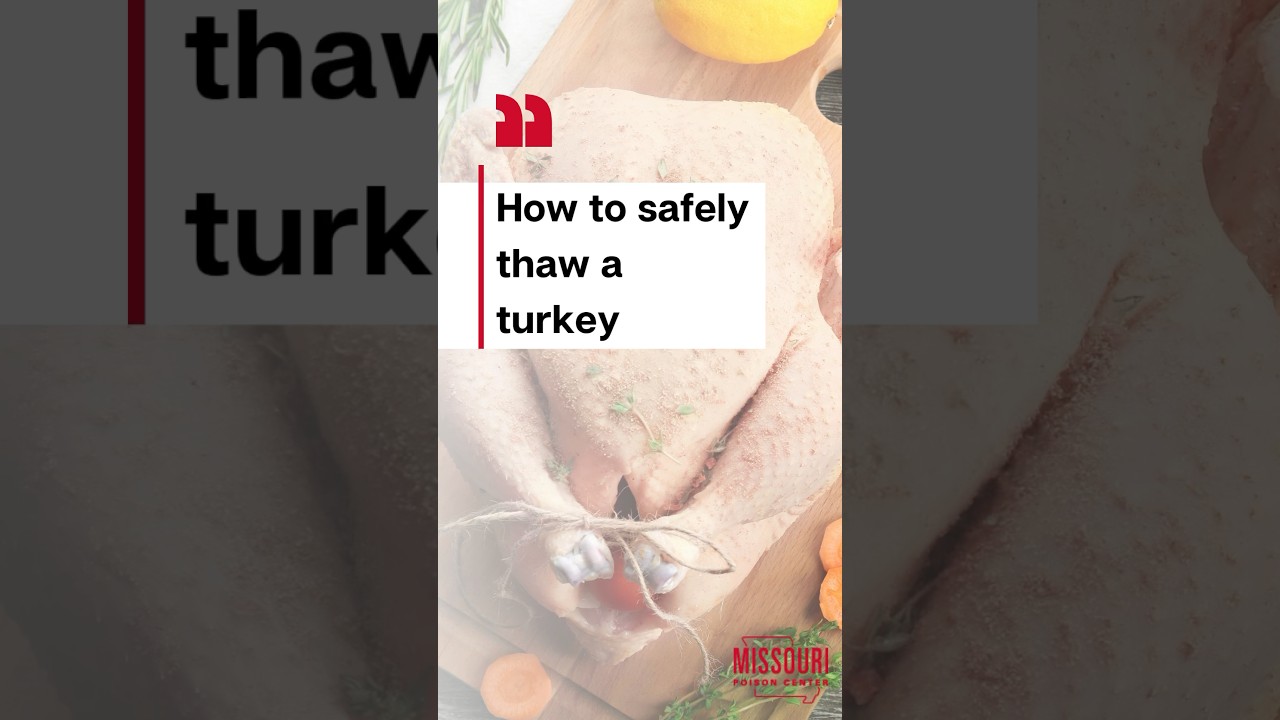Raw turkey on top of a wooden table with vegetables around it
