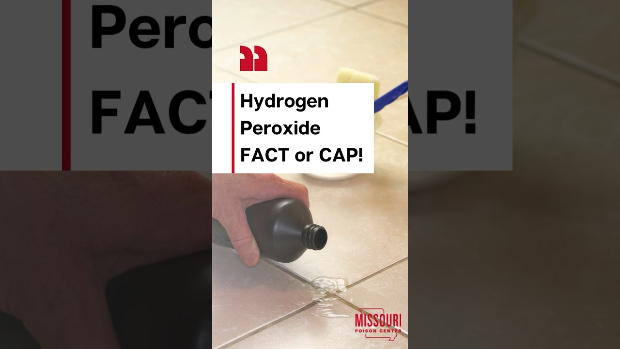 Hand holding a black hydrogen peroxide bottle while pouring some of it on a white tile floor